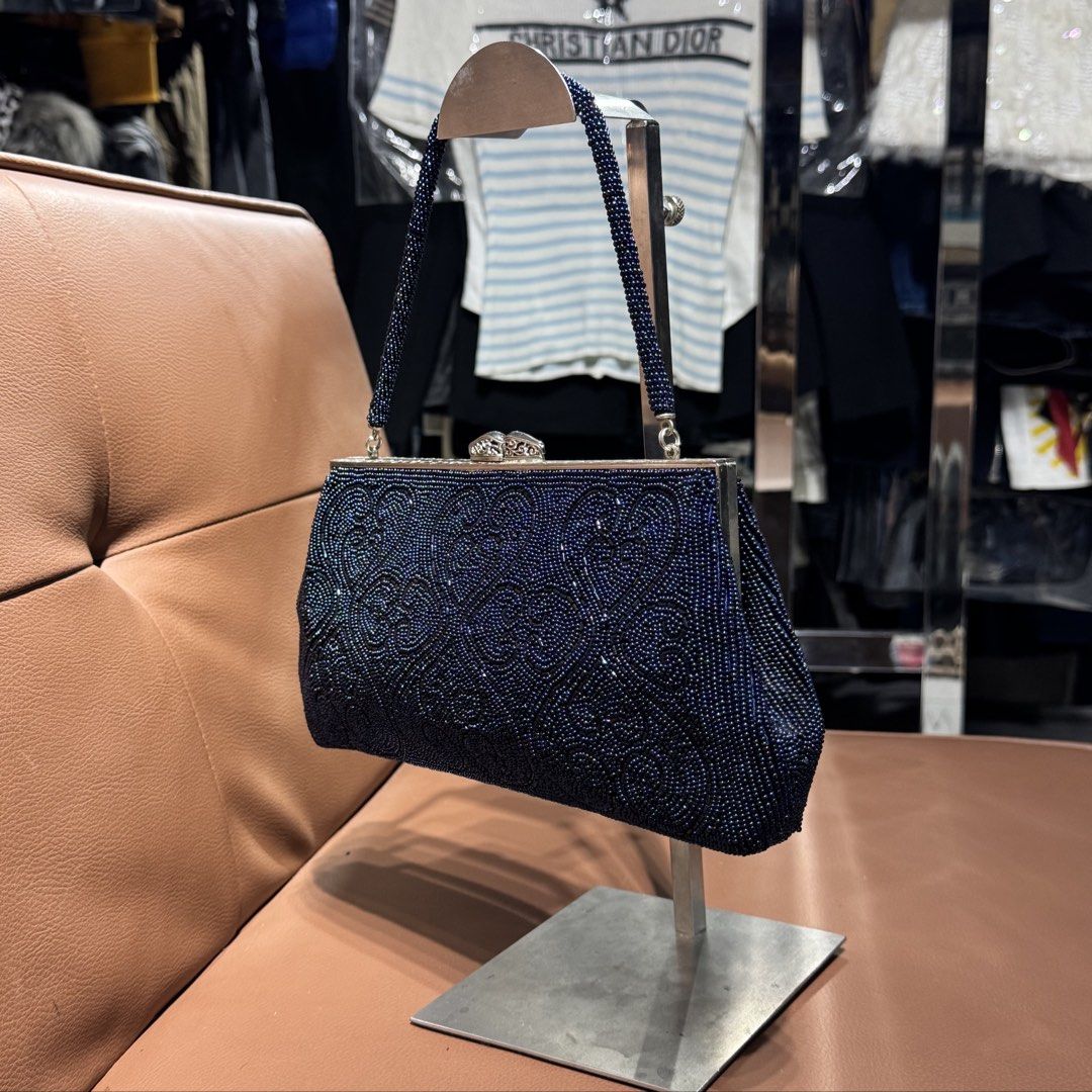 Dark Blue Beaded handmade Evening Clutch Bag with Strap (Category: Clutches) located in Rizal. Submitted by houseofbell (Listing ID 1471100235, Image 3). Description: - Color: Dark blue with intricate swirl beadwork - Hardware: Silver-tone kiss-lock clasp - Handle: Single beaded top handle - Interior: Vibrant blue satin lining with convenient slip pockets - Shape: Structured trapezoid - Condition: Excellent, ready for your next special occasion! 