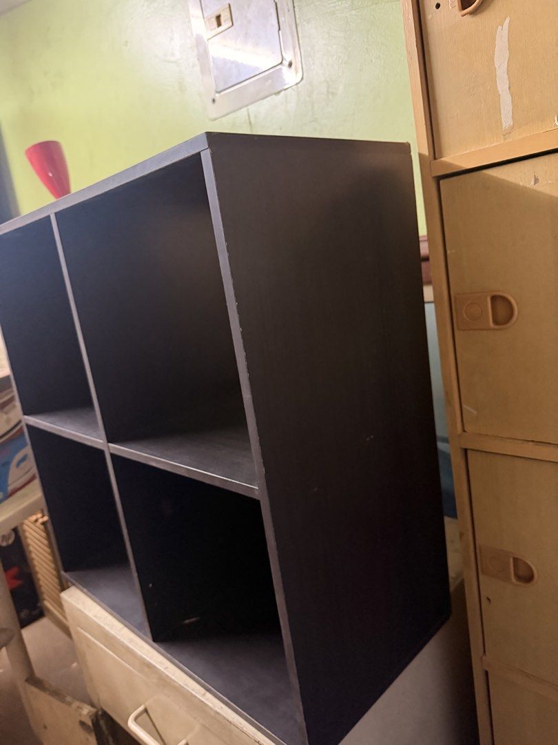Dark brown 4-cube storage shelf organizer (Category: Shelves, Cabinets & Racks) located in Quezon City. Submitted by chaelmangibin (Listing ID 1470989473, Image 3). Description: - Dark brown 4-cube wooden storage shelf - Features 2 cubbies with backing panels and 2 open-through compartments - Great size for organizing books, toys, or small bins - Sturdy construction with minor surface wear from previous use - Easy setup to declutter and organize 