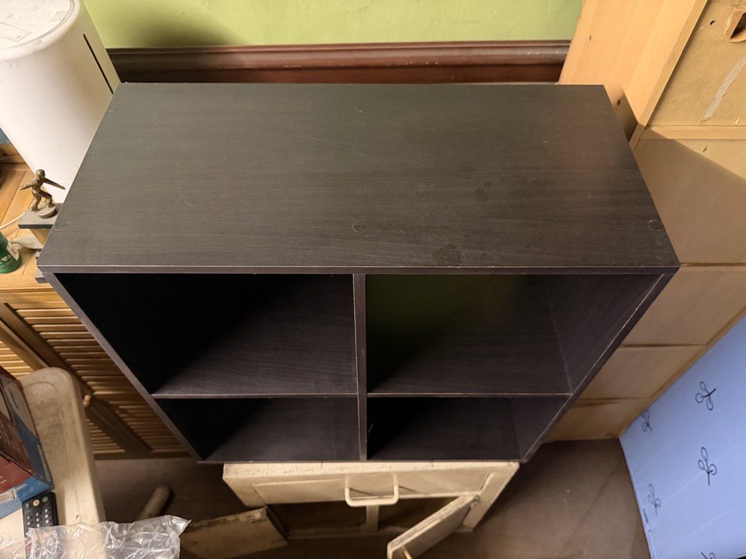 Dark brown 4-cube storage shelf organizer (Category: Shelves, Cabinets & Racks) located in Quezon City. Submitted by chaelmangibin (Listing ID 1470989473, Image 2). Description: - Dark brown 4-cube wooden storage shelf - Features 2 cubbies with backing panels and 2 open-through compartments - Great size for organizing books, toys, or small bins - Sturdy construction with minor surface wear from previous use - Easy setup to declutter and organize 