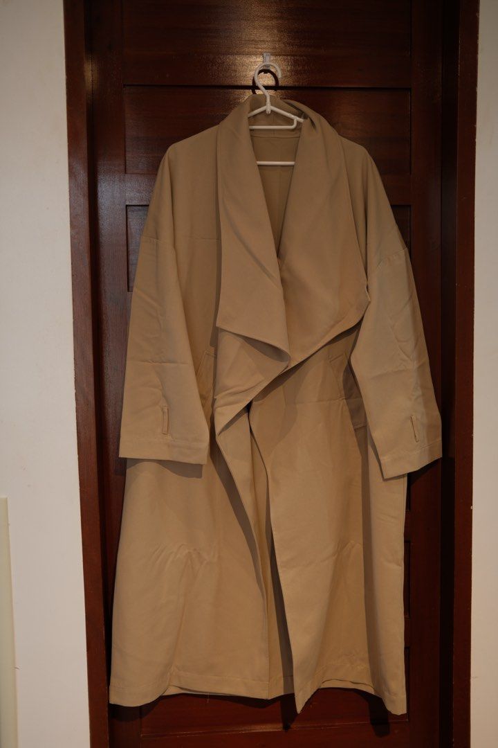 Dazy Beige Oversized Trench Coat Size M (Category: Coats, Jackets and Outerwear) located in Makati City. Submitted by nomoreclutterph (Listing ID 1471037515, Image 1). Description: - Brand: Dazy - Size: Medium (tag attached) - Color: Classic Beige - Style: Long midi length, draped lapels, relaxed drop shoulders, buttonless open front - Material: Lightweight fabric, ideal for layering - Condition: Clean, ready to wear - Can fit size Medium to Larg