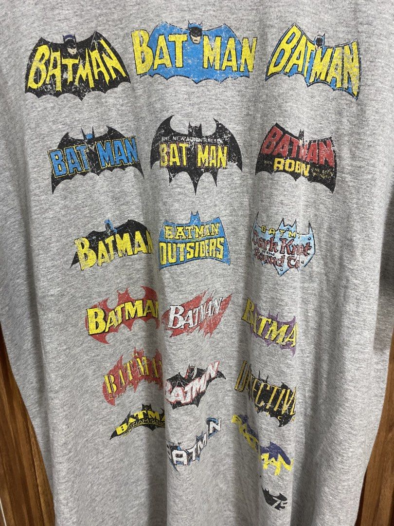 DC Comics Batman Logo Evolution Graphic T-Shirt Gray Size L (Category: Tshirts & Polo Shirts ) located in Caloocan City. Submitted by heatedcaps4425 (Listing ID 1471098524, Image 2). Description: - Official DC Comics Originals merchandise - Gray graphic tee featuring various Batman logo iterations and titles - Size: Large (Made in Honduras) - Material: Comfortable cotton fabric blend - Design: Crew neckline and short sleeves - Condition: Clean ov