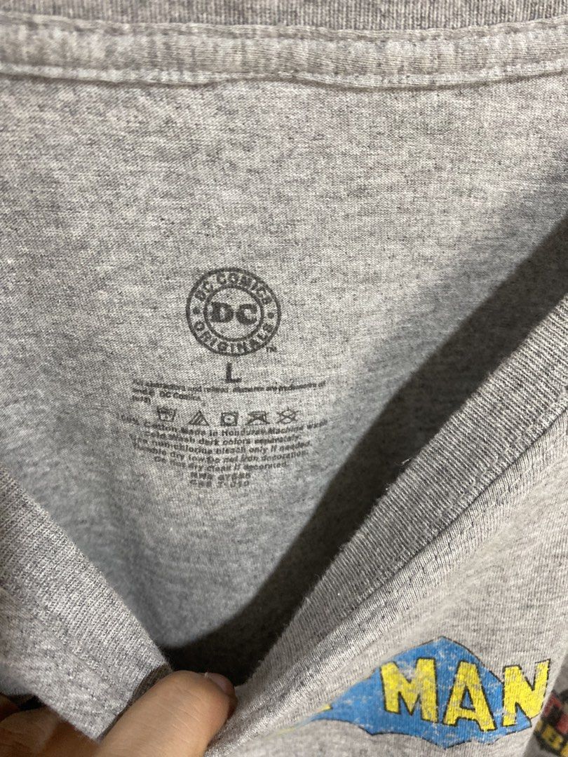 DC Comics Batman Logo Evolution Graphic T-Shirt Gray Size L (Category: Tshirts & Polo Shirts ) located in Caloocan City. Submitted by heatedcaps4425 (Listing ID 1471098524, Image 3). Description: - Official DC Comics Originals merchandise - Gray graphic tee featuring various Batman logo iterations and titles - Size: Large (Made in Honduras) - Material: Comfortable cotton fabric blend - Design: Crew neckline and short sleeves - Condition: Clean ov