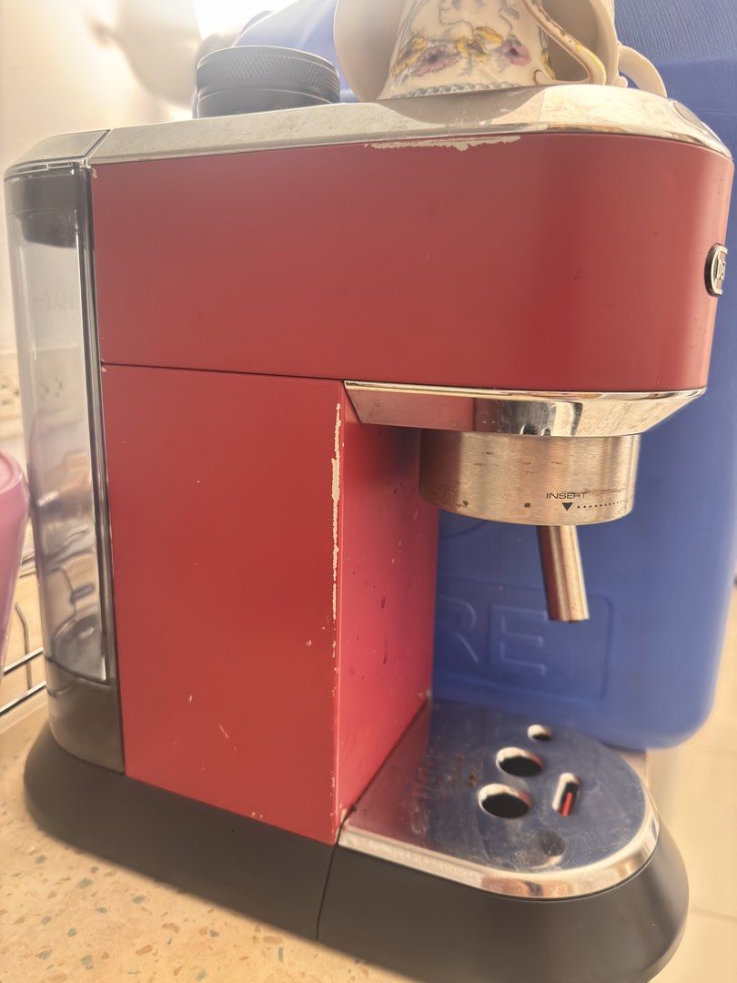 DeLonghi Dedica Espresso Machine Red (Category: Coffee Machines & Makers) located in Makati City. Submitted by daneeaa (Listing ID 1471032708, Image 2). Description: - Brand: DeLonghi - Color: Bright red - Features: Built-in steam wand, rear water tank, and stainless steel drip tray - Size: Compact design, ideal for small kitchen counters - Condition: Fully functional, but shows noticeable paint chipping and cosmetic wear along the edges and side