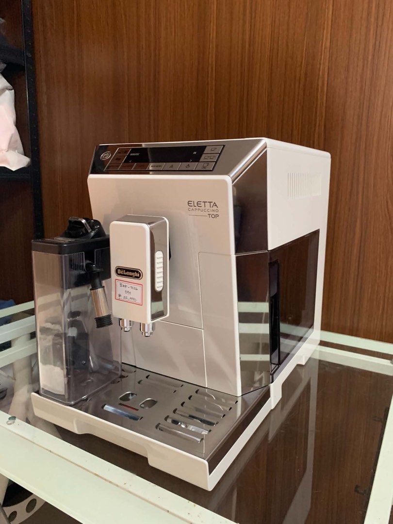 DeLonghi Eletta Cappuccino Top Espresso Machine (Category: Coffee Machines & Makers) located in Pulilan. Submitted by sebbii (Listing ID 1470963807, Image 3). Description: - Authentic DeLonghi Eletta Cappuccino Top espresso maker - Elegant white and silver finish - Includes LatteCrema milk carafe attachment - Digital display panel with one-touch buttons for cappuccino, flat white, latte, and long coffee - Comes complete with drip tray and spouts 