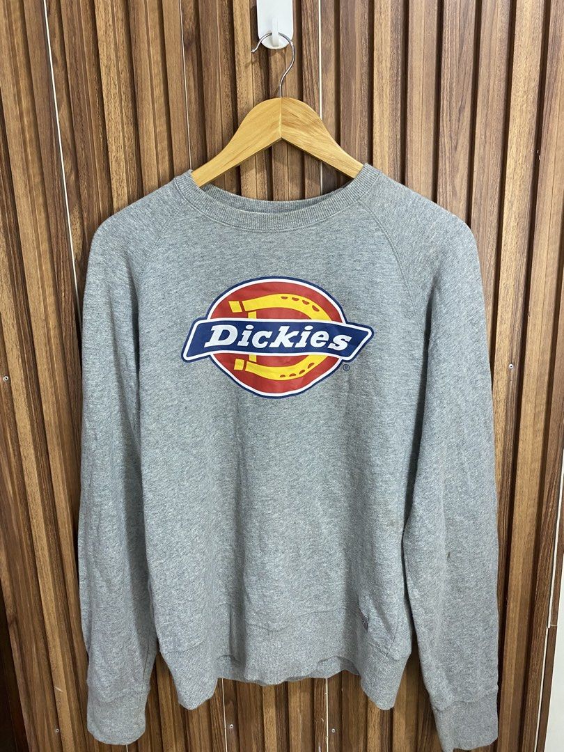 Dickies Grey Sweatshirt Size S (Category: Coats, Jackets and Outerwear) located in Caloocan City. Submitted by heatedcaps4425 (Listing ID 1471098196, Image 1). Description: - Brand: Dickies - Color: Grey - Size: Small - Design: Large chest logo graphic with iconic Williamson-Dickies tagging - Details: Ribbed collar, cuffs, and hem for a snug fit - Accents: Small branded patch near the bottom hem and inner neck taping with repeating logo text - Co