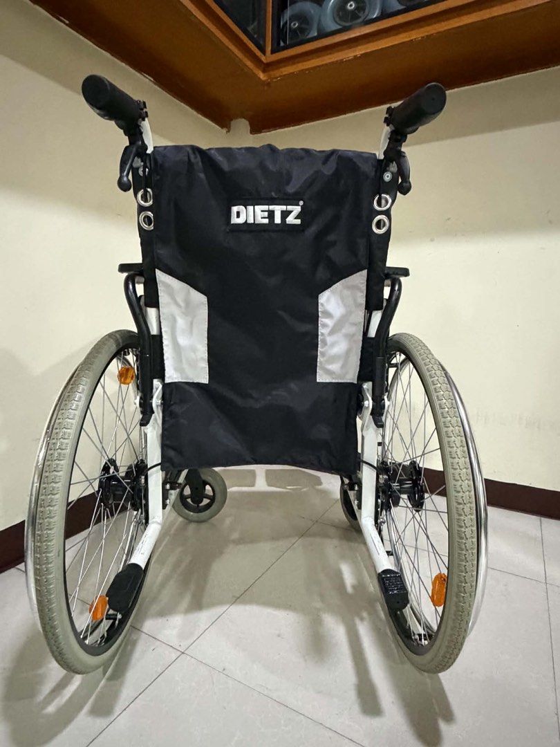 Dietz CANEO-E Wheelchair (Category: Wheelchairs) located in Manila. Submitted by calmdolphin.87b0e4 (Listing ID 1470960042, Image 2). Description: Dietz CANEO-E lightweight folding wheelchair. Black fabric seat and backrest with branding on the rear. White metal frame, grey pneumatic tires, sturdy push handles, and adjustable footrests included. Clean condition, works smoothly, easy to transport..
