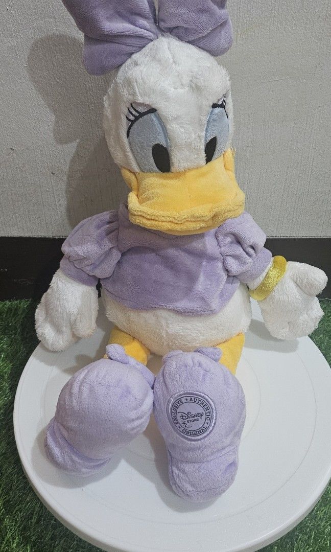 Disney store daisy duck plush (Category: Plushies & Soft Toys) located in Umingan. Submitted by liezelsona48963 (Listing ID 1471044313, Image 1). Description: Disney Store Daisy Duck Plush measuring approximately 15 to 18 inches tall, featuring a lavender-purple dress and matching shoes with an official Disney Store stamp on the mop gcash.