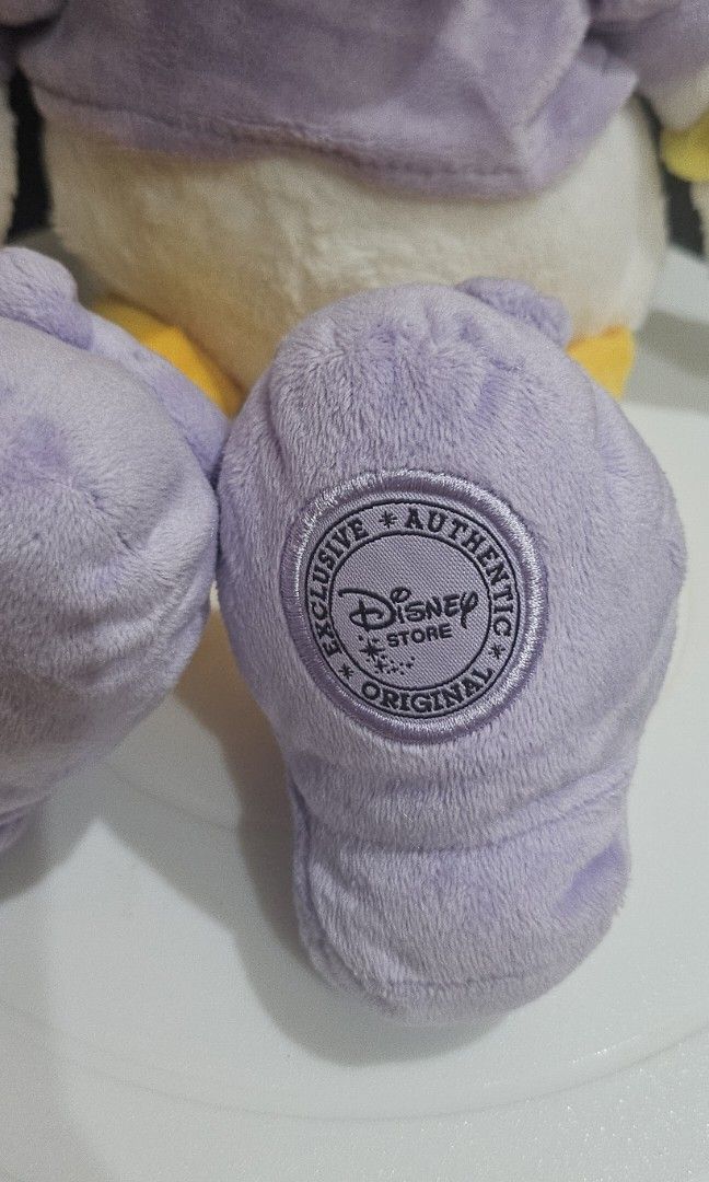 Disney store daisy duck plush (Category: Plushies & Soft Toys) located in Umingan. Submitted by liezelsona48963 (Listing ID 1471044313, Image 2). Description: Disney Store Daisy Duck Plush measuring approximately 15 to 18 inches tall, featuring a lavender-purple dress and matching shoes with an official Disney Store stamp on the mop gcash.