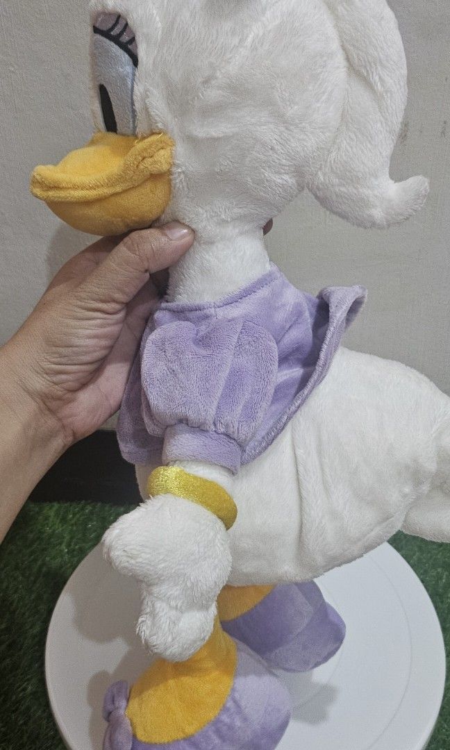 Disney store daisy duck plush (Category: Plushies & Soft Toys) located in Umingan. Submitted by liezelsona48963 (Listing ID 1471044313, Image 3). Description: Disney Store Daisy Duck Plush measuring approximately 15 to 18 inches tall, featuring a lavender-purple dress and matching shoes with an official Disney Store stamp on the mop gcash.