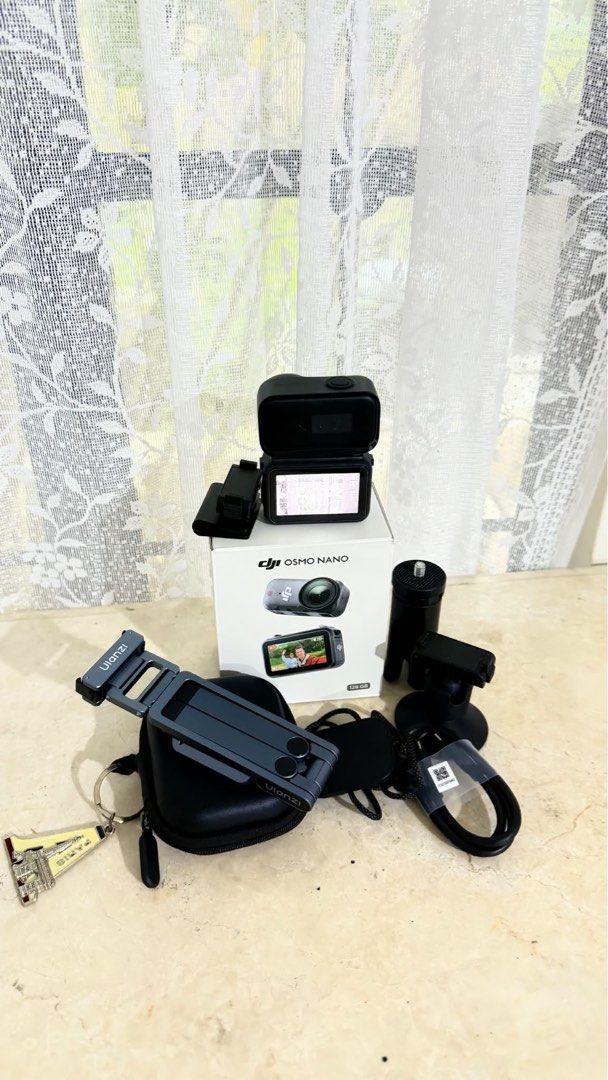 DJI Osmo Nano 128GB with DJI Mic Mini Transmitter (Category: Cameras) located in Caloocan City. Submitted by gelligadi (Listing ID 1471023044, Image 1). Description: - Model: DJI Osmo Nano Action Camera - Storage: 128GB capacity - Condition: Tested and working great, screen lights up clearly - Includes original retail box - Ulanzi MA37 quick release mini tripod included - Carrying case, magnetic mounts, and charging cable included - All accessori