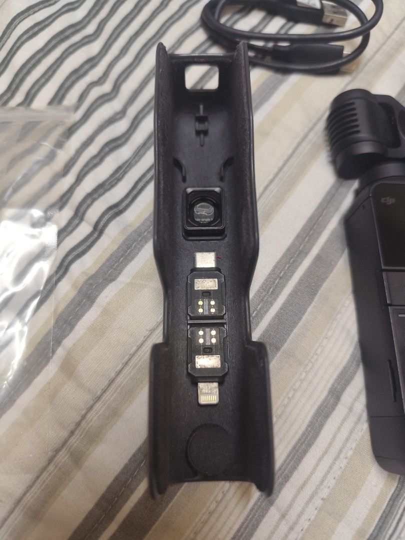 DJI Osmo Pocket 2 Complete Set + Waterproof Case | Negotiable (Category: Video Cameras) located in Taguig. Submitted by alyannasilang (Listing ID 1471022483, Image 2). Description: Selling my DJI Osmo Pocket 2 since I've upgraded to the Pocket 4 Pro. Used for work shoots and travel over the years. Still a great compact camera for anyone looking for a portable camera with a 3-axis gimbal for smooth videos. INCLUSIONS - DJI Osmo Pocket 2 camera - S