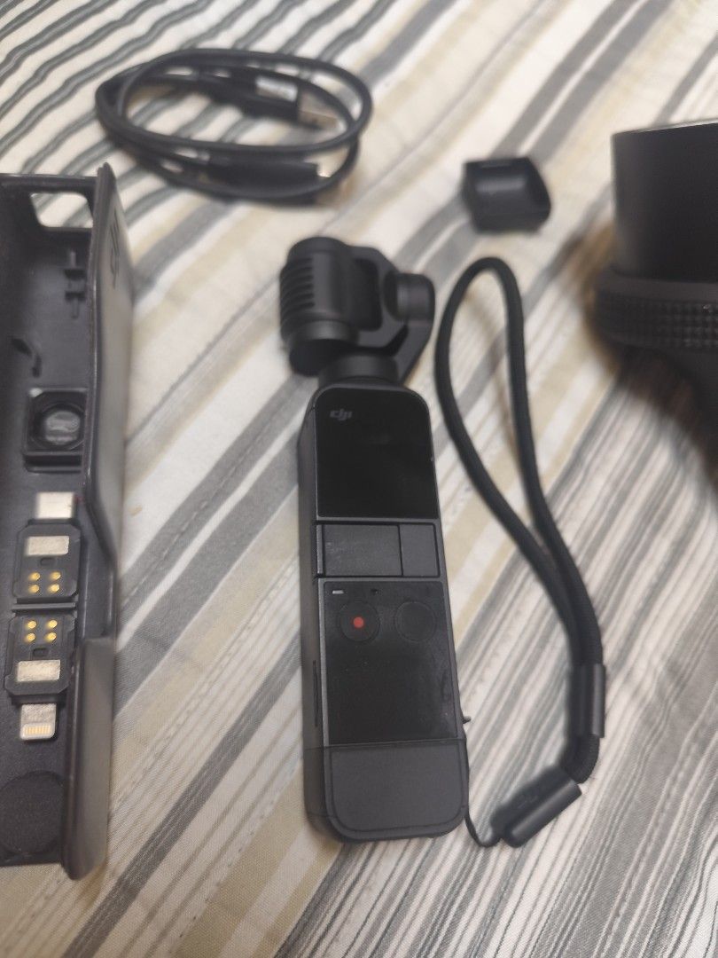 DJI Osmo Pocket 2 Complete Set + Waterproof Case | Negotiable (Category: Video Cameras) located in Taguig. Submitted by alyannasilang (Listing ID 1471022483, Image 3). Description: Selling my DJI Osmo Pocket 2 since I've upgraded to the Pocket 4 Pro. Used for work shoots and travel over the years. Still a great compact camera for anyone looking for a portable camera with a 3-axis gimbal for smooth videos. INCLUSIONS - DJI Osmo Pocket 2 camera - S