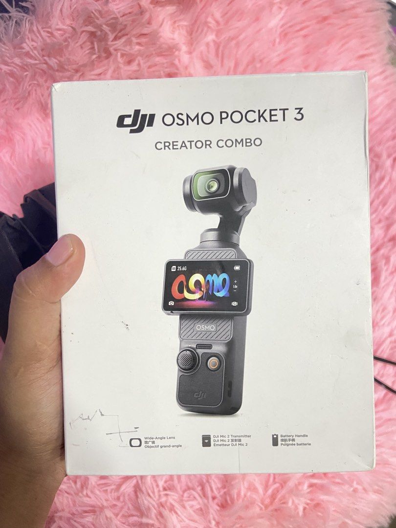 DJI Osmo Pocket 3 Creator Combo (Category: Cameras) located in Manila. Submitted by joyceeyyyy (Listing ID 1470957343, Image 2). Description: - Includes handheld gimbal camera and battery handle for extended shooting - DJI Mic 2 transmitter with furry windscreen and clip magnet for pro audio - Wide-angle lens and mini tripod included for versatile framing - Comes with original carrying bag, cables, power adapters, and retail box - Perfect all-in-