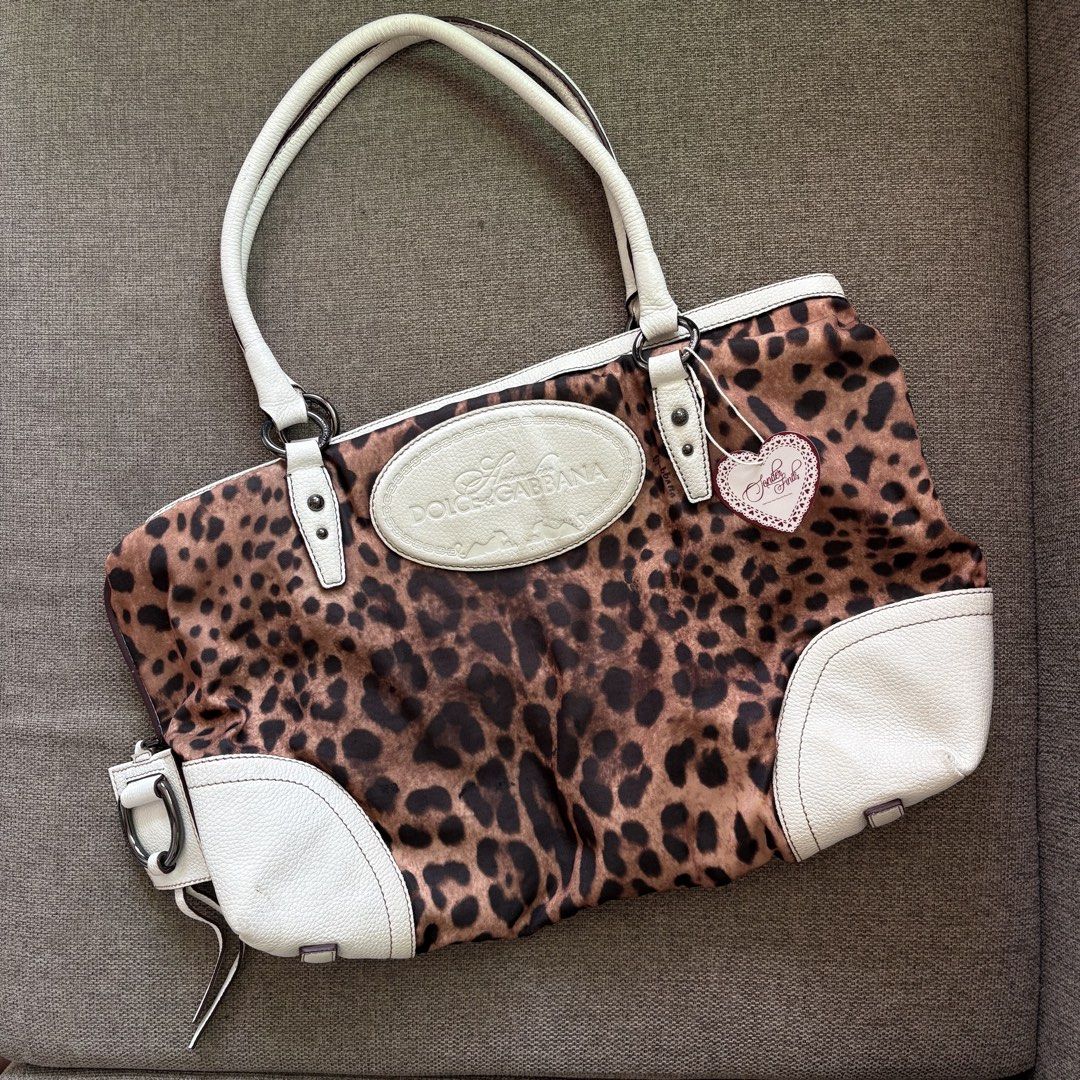 Dolce & Gabbana Leopard Print Maxi Tote Bag (Category: Tote Bags) located in Bacolod City. Submitted by ayenkhey (Listing ID 1471047367, Image 1). Description: - Authentic Dolce & Gabbana leopard print tote bag with white leather trim and handles - Features a large embossed logo patch on the front - Secure zip closure with brown fabric lining and interior zip pocket - Crafted in Italy - Condition: Normal signs of use around the leather corners an