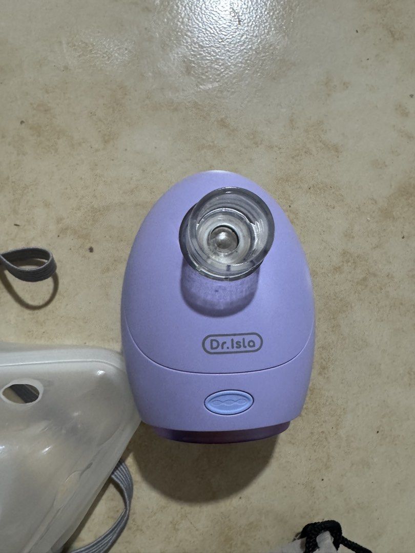 dr.isla Portable Handheld Mesh Nebulizer Machine (Category: Medical Supplies & Tools) located in Quezon City. Submitted by silvergem_96 (Listing ID 1471072299, Image 2). Description: - Brand: Dr.Isla - Color: Purple - Power Source: Battery or USB - Included: Adult mask, child mask, mouthpiece, and grey logo storage pouch - Condition note: One mask is still sealed in plastic - Portable and compact design, perfect for home or travel respiratory car