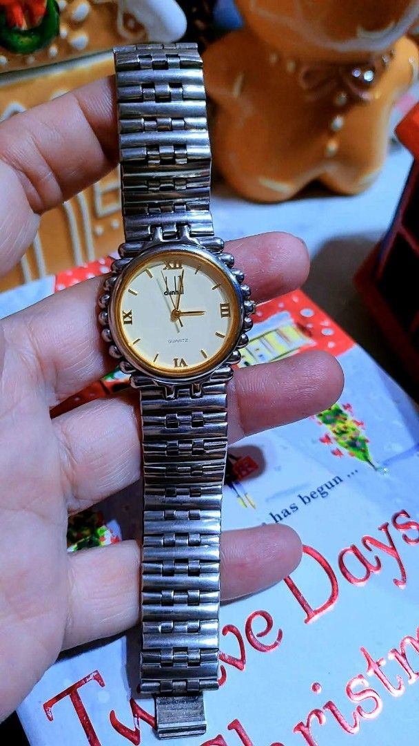 Dunhill Quartz Watch Two-Tone Roman Numeral Dial (Category: Luxury Watches) located in Baliuag. Submitted by marieannfernando23 (Listing ID 1471051069, Image 2). Description: - Brand: Dunhill - Movement: Battery-operated quartz - Dial: Round white dial with elegant gold Roman numerals - Bezel: Distinctive beaded bezel design - Strap: Two-tone silver and gold metal bracelet - Fit: Standard wrist size - Condition: Excellent working condition, ready