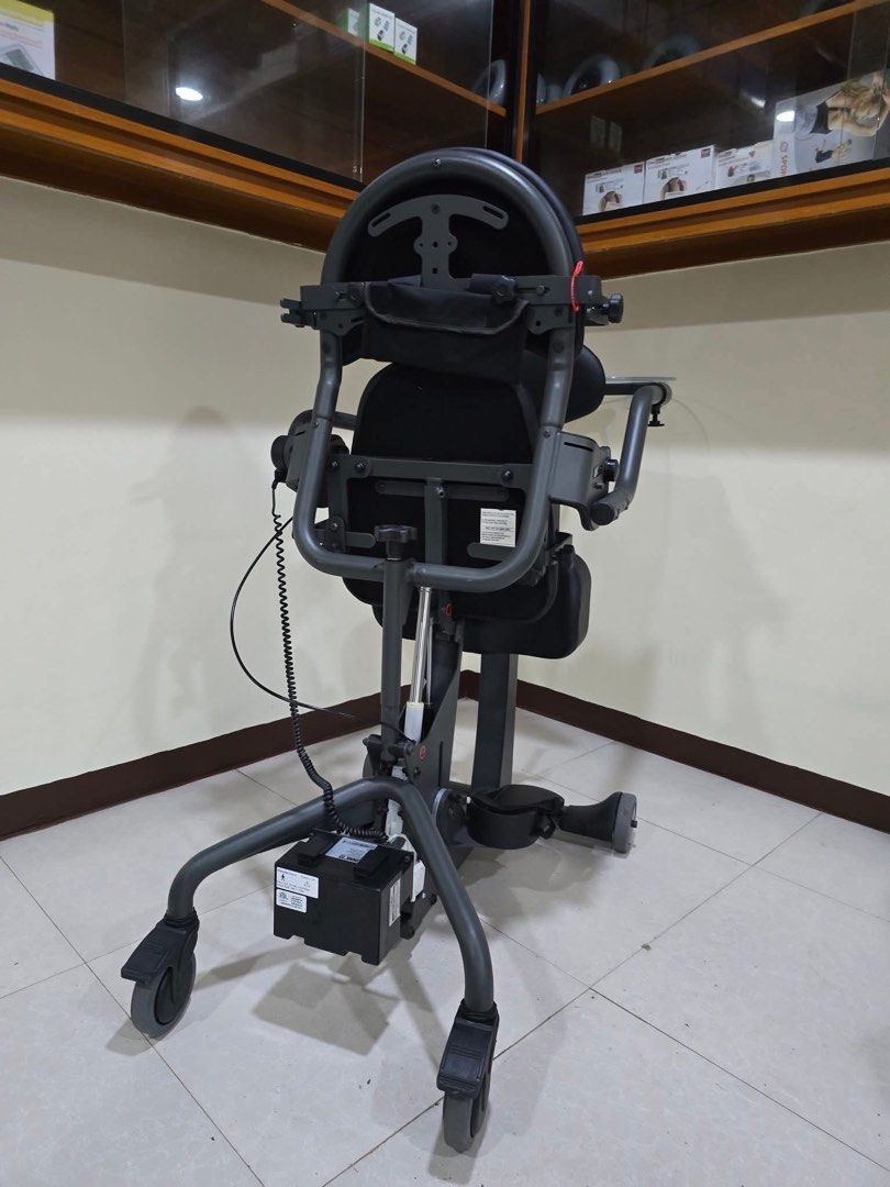 EasyStand Evolv Mobile Standing Wheelchair (Category: Wheelchairs) located in Manila. Submitted by calmdolphin.87b0e4 (Listing ID 1470955062, Image 2). Description: - Model: EasyStand Evolv motorized standing wheelchair - Color: Sleek dark grey - Lift Mechanism: Motorized with a rear-mounted battery pack and convenient hand control - Comfort & Support: Padded seat, backrest, knee supports, and adjustable armrests/footplates - Accessories: Include