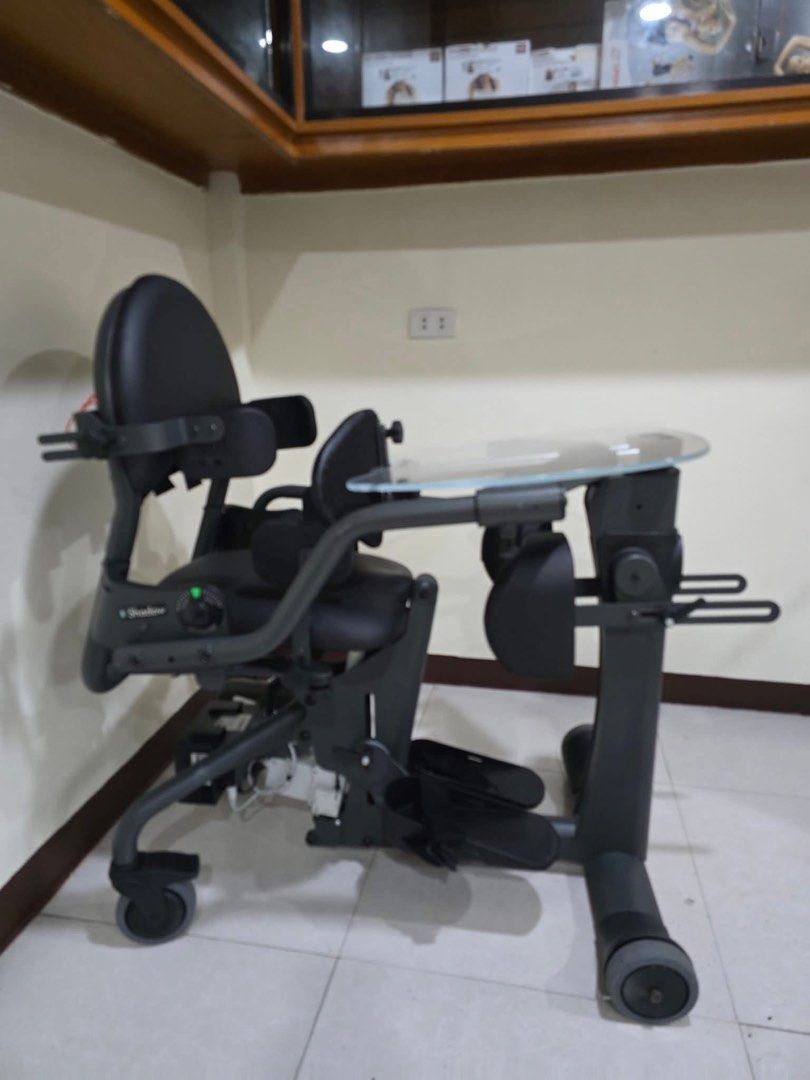 EasyStand Evolv Mobile Standing Wheelchair (Category: Wheelchairs) located in Manila. Submitted by calmdolphin.87b0e4 (Listing ID 1470955062, Image 3). Description: - Model: EasyStand Evolv motorized standing wheelchair - Color: Sleek dark grey - Lift Mechanism: Motorized with a rear-mounted battery pack and convenient hand control - Comfort & Support: Padded seat, backrest, knee supports, and adjustable armrests/footplates - Accessories: Include