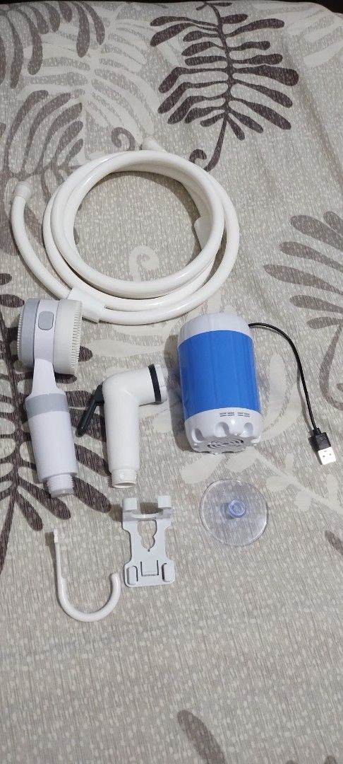 Electric Shower Portable Mobile USB Charging Camping Bath (Category: Water Heater & Instant Showers) located in Makati City. Submitted by chamarket.2022 (Listing ID 1471091112, Image 2). Description: - Portable electric shower set ideal for camping, pets, and car washing - USB rechargeable with approx. 1 hour continuous runtime - Lightweight and travel-friendly at only 0.6kg - Complete set includes pump, hose, shower head, brush attachment, mount