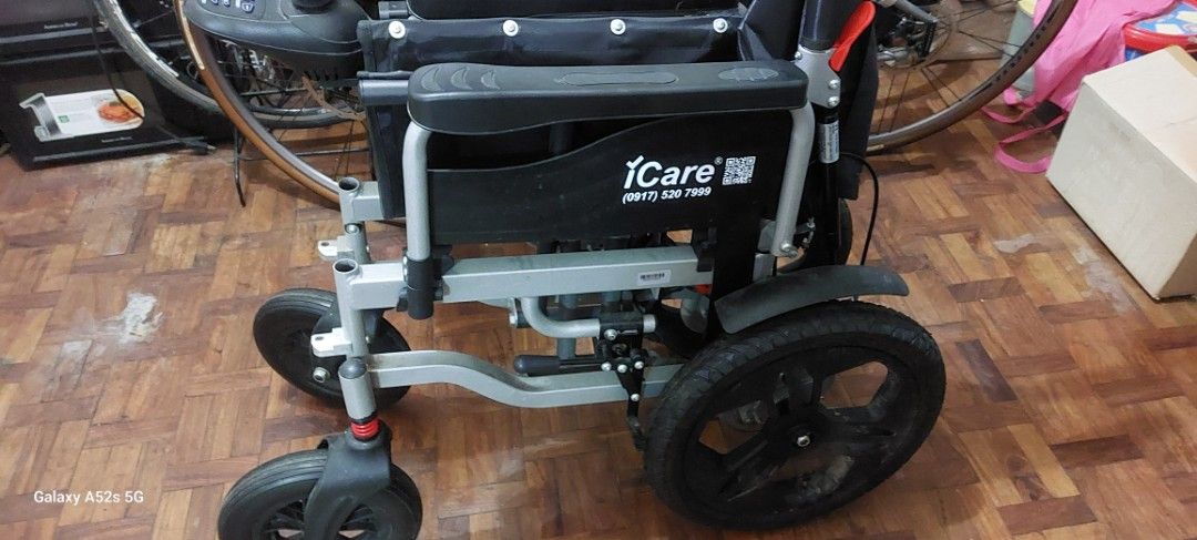 ELECTRIC WHEEL CHAIR iCare E510 (Category: Wheelchairs) located in Las Pinas. Submitted by purecloud_696d26 (Listing ID 1471059176, Image 2). Description: - Brand: iCare - Type: Foldable wheelchair for easy storage and transport - Frame: Durable silver metal frame - Seating: Comfortable black fabric seat and backrest - Wheels: Large rear wheels with fenders and shock-absorbing front casters - Comfort & Support: Built-in gas springs and sturdy arm