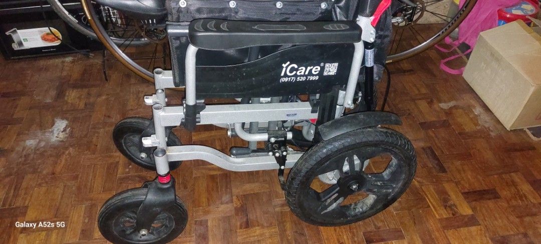 ELECTRIC WHEEL CHAIR iCare E510 (Category: Wheelchairs) located in Las Pinas. Submitted by purecloud_696d26 (Listing ID 1471059176, Image 3). Description: - Brand: iCare - Type: Foldable wheelchair for easy storage and transport - Frame: Durable silver metal frame - Seating: Comfortable black fabric seat and backrest - Wheels: Large rear wheels with fenders and shock-absorbing front casters - Comfort & Support: Built-in gas springs and sturdy arm