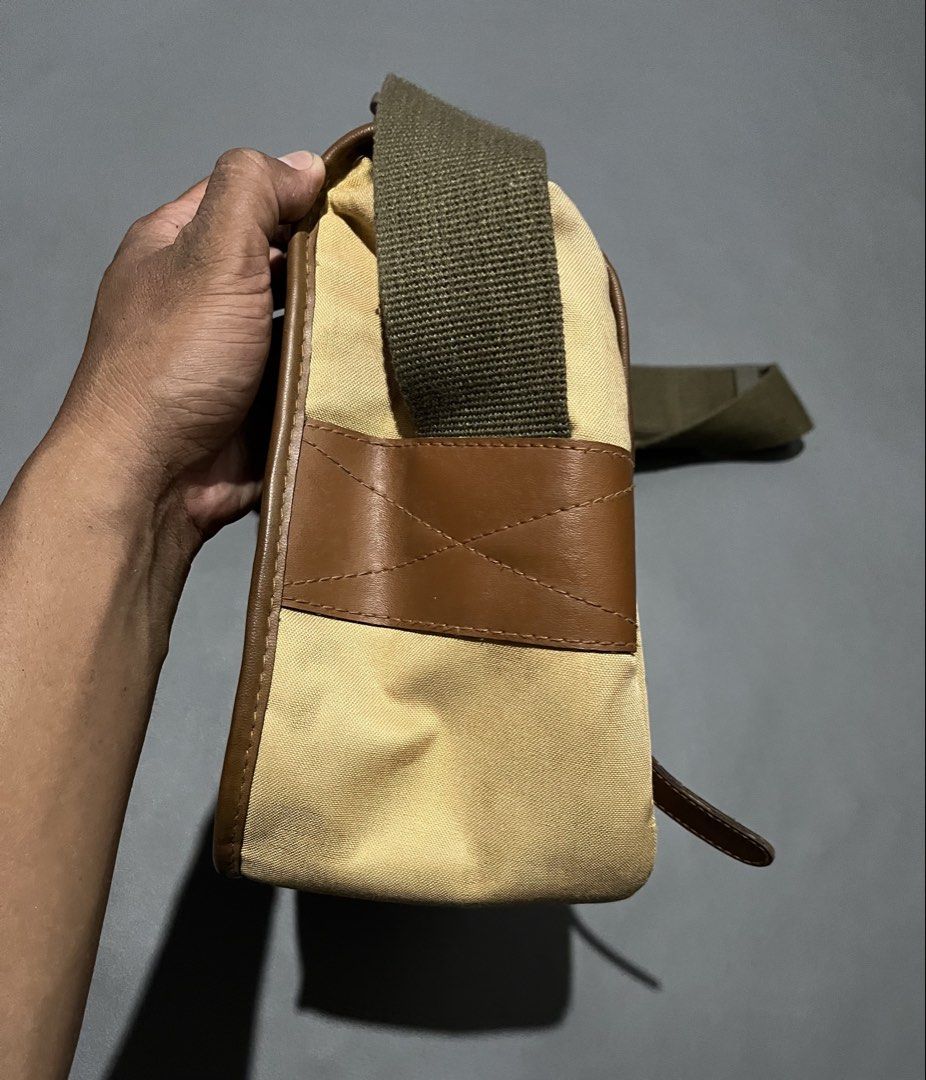 EOS Canvas and Leather Messenger Bag (Category: Sling Bags) located in General Santos City (Dadiangas). Submitted by thiftnibadi3 (Listing ID 1471052403, Image 2). Description: - Material: Durable tan canvas with stylish brown leather trim - Straps: Adjustable olive green shoulder strap with a comfortable padded section and secure metal buckle closures - Pockets: Dual front pockets hidden under the main flap - Interior: Spacious main compartment 