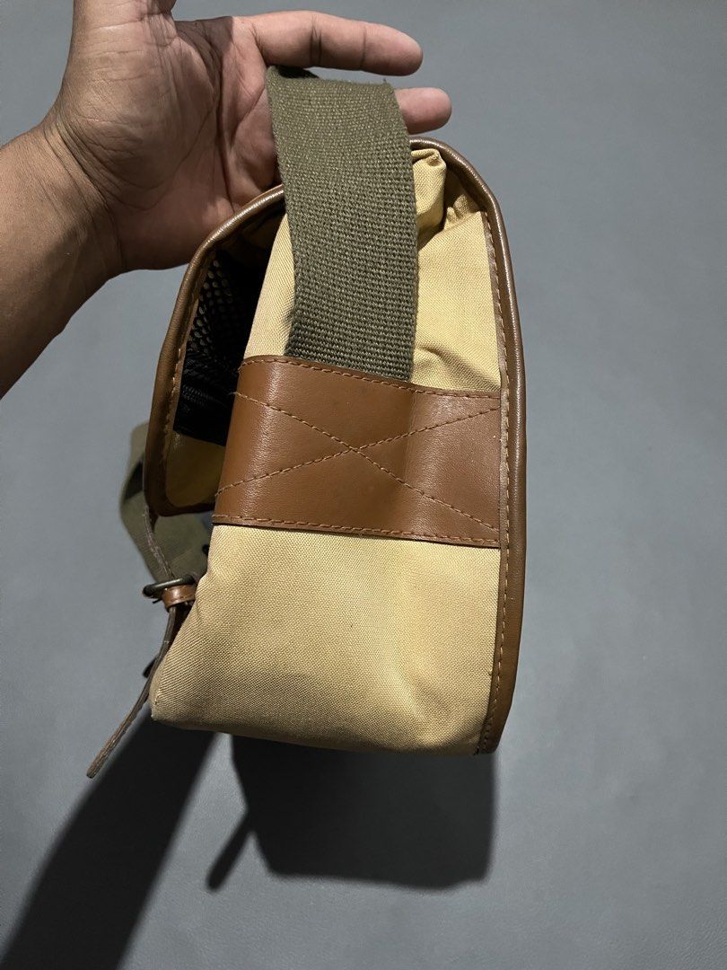 EOS Canvas and Leather Messenger Bag (Category: Sling Bags) located in General Santos City (Dadiangas). Submitted by thiftnibadi3 (Listing ID 1471052403, Image 3). Description: - Material: Durable tan canvas with stylish brown leather trim - Straps: Adjustable olive green shoulder strap with a comfortable padded section and secure metal buckle closures - Pockets: Dual front pockets hidden under the main flap - Interior: Spacious main compartment 