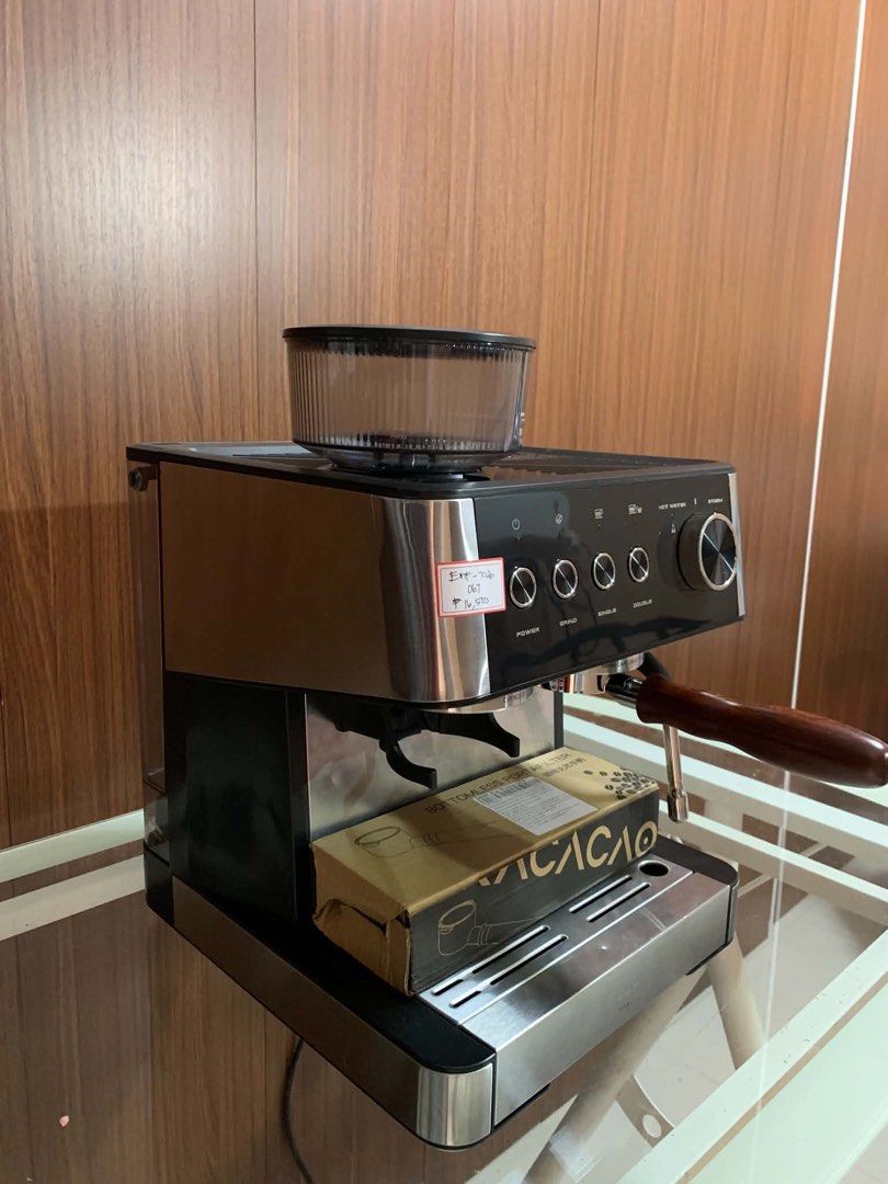 Espresso Machine with Built-in Grinder and Bottomless Portafilter (Category: Coffee Machines & Makers) located in Pulilan. Submitted by sebbii (Listing ID 1470961494, Image 2). Description: - Type: Espresso machine with integrated bean hopper - Color/Finish: Stainless steel and black - Features: Adjustable grind settings, steam wand, and rotary knob for hot water and steam - Controls: Dedicated buttons for single and double shots - Inclusions: Co