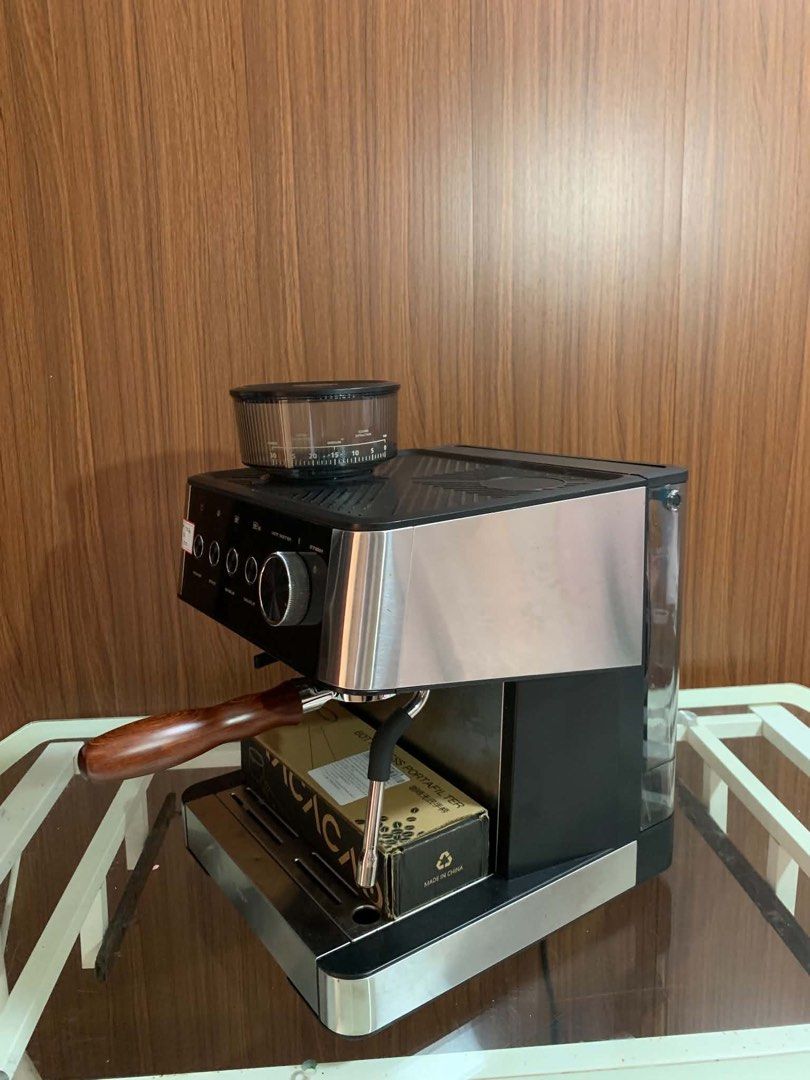 Espresso Machine with Built-in Grinder and Bottomless Portafilter (Category: Coffee Machines & Makers) located in Pulilan. Submitted by sebbii (Listing ID 1470961494, Image 3). Description: - Type: Espresso machine with integrated bean hopper - Color/Finish: Stainless steel and black - Features: Adjustable grind settings, steam wand, and rotary knob for hot water and steam - Controls: Dedicated buttons for single and double shots - Inclusions: Co