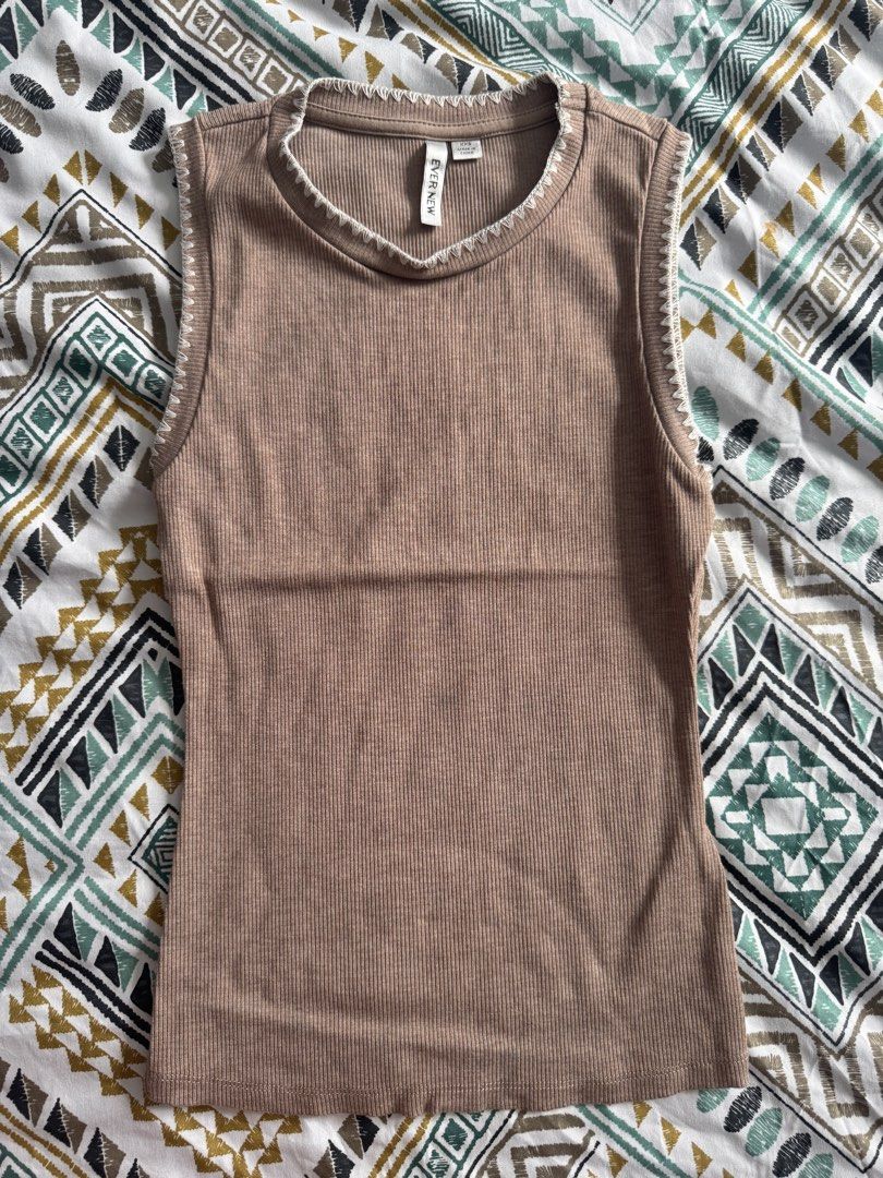 Evernew Brown Ribbed Tank Top XXS (Category: Sleeveless) located in Manila. Submitted by decluterthings888 (Listing ID 1471077796, Image 1). Description: - Brand: Evernew - Color: Versatile brown with contrast white decorative stitching - Size: XXS (snug fit) - Material: Comfortable stretchy fabric - Origin: Made in China - Style: Sleeveless scoop neckline, perfect for pairing with jeans or skirts for casual daily wear.