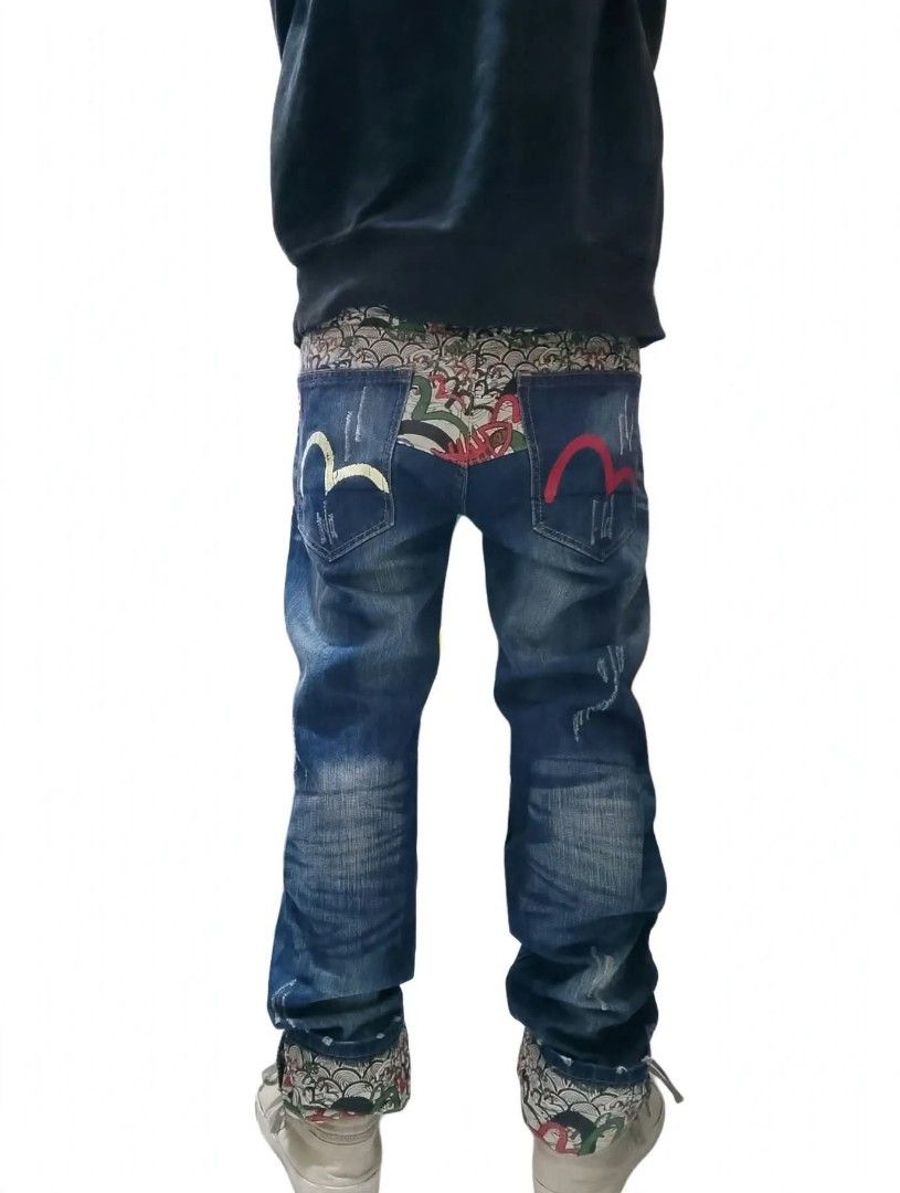 EVISU (INSPIRED) SLIM STRAIGHT JEANS (Category: Jeans) located in Binan City. Submitted by jov_abii (Listing ID 1470948848, Image 1). Description: - Size: 31 - Fit: Relaxed streetwear - Design: Distressed details with front whiskers - Unique accents: Patterned fabric on waistband and rolled cuffs - Pockets: Two back pockets with yellow and pink embroidered gullwing designs DIMENSIONS 📐(INCHES) WAIST 31 LENGTH: 42 (UNCUFFED) 38 (CUFFED) THIGHS: 1