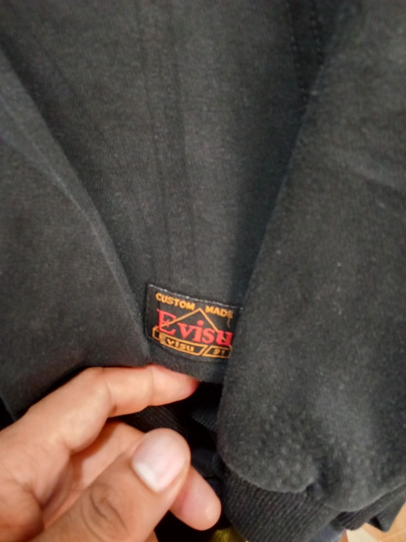 Evisukuro Black Zip-Up Hoodie (Category: Coats, Jackets and Outerwear) located in Caloocan City. Submitted by rajjuuu (Listing ID 1470976803, Image 3). Description: - Brand: Evisukuro - Color: Black with white seagull chest graphic - Style: Zip-up hoodie with drawstring hood and front pockets - Details: Custom-made label near the hem, branded neck tag, ribbed cuffs and hem - Condition: Good overall wear with slight fading from washing.