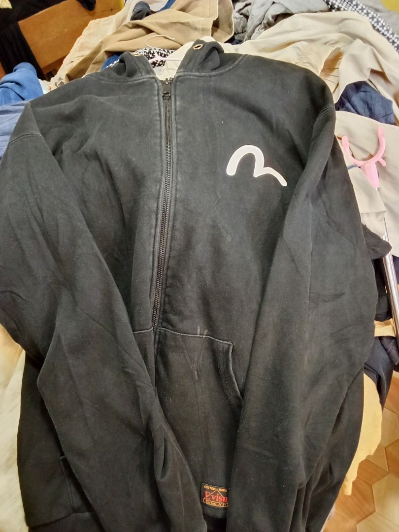 Evisukuro Black Zip-Up Hoodie (Category: Coats, Jackets and Outerwear) located in Caloocan City. Submitted by rajjuuu (Listing ID 1470976803, Image 2). Description: - Brand: Evisukuro - Color: Black with white seagull chest graphic - Style: Zip-up hoodie with drawstring hood and front pockets - Details: Custom-made label near the hem, branded neck tag, ribbed cuffs and hem - Condition: Good overall wear with slight fading from washing.