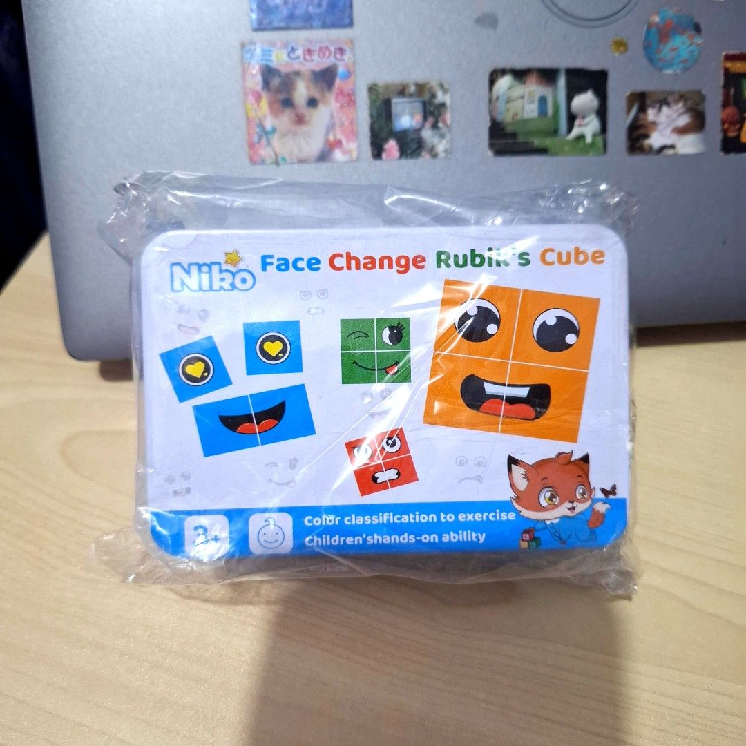 Face Change Rubik's Cube Puzzle Toy (Category: Board Games & Puzzles) located in Quezon City. Submitted by an.marie (Listing ID 1470938164, Image 1). Description: - Brand new and sealed in original metal tin case - Fun face-changing puzzle game for kids aged 3 and up - Helps develop color classification and hand-eye coordination - Great as a mini brain teaser, gift, or party favor - 100% unopened and untouched.