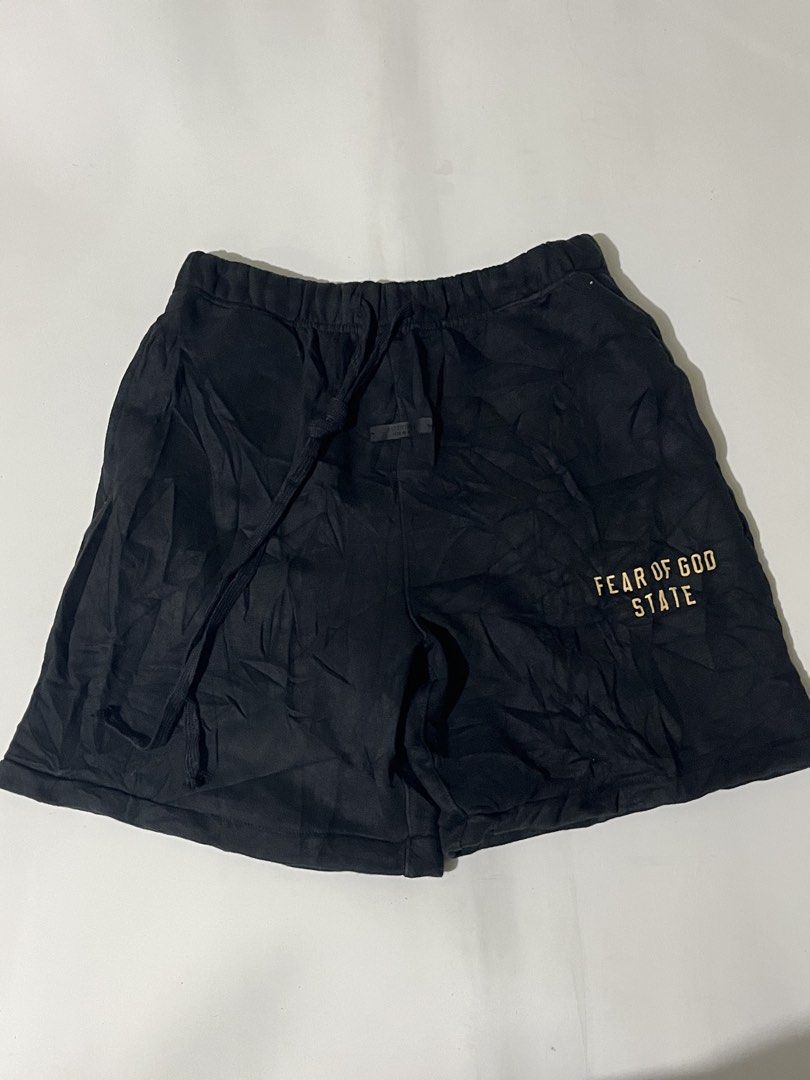 Fear of God Essentials Black State Shorts (Category: Shorts) located in Pilar. Submitted by fast-flip-ni-miko. (Listing ID 1471069015, Image 1). Description: - Brand: Fear of God Essentials - Color: Classic Black - Material: Premium cotton fleece for ultimate comfort - Waistband: Elastic with extra-long matching drawstrings - Branding: Rubberized Essentials label on front waistband & gold 'Fear of God State' print on left leg - Authenticity: Incl