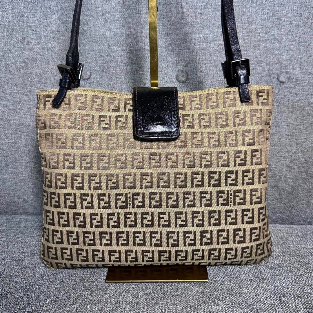 Fendi Zucca FF Monogram Canvas Shoulder Bag Brown (Category: Luxury Bags & Wallets) located in Madrid. Submitted by jhunaceee (Listing ID 1470943704, Image 3). Description: - Authentic Fendi vintage shoulder bag - Iconic brown Zucca monogram canvas - Adjustable dark leather double straps - Secure front flap with magnetic snap closure - Spacious interior that easily fits daily essentials - Perfect daily carryall for commutes or weekend outings.