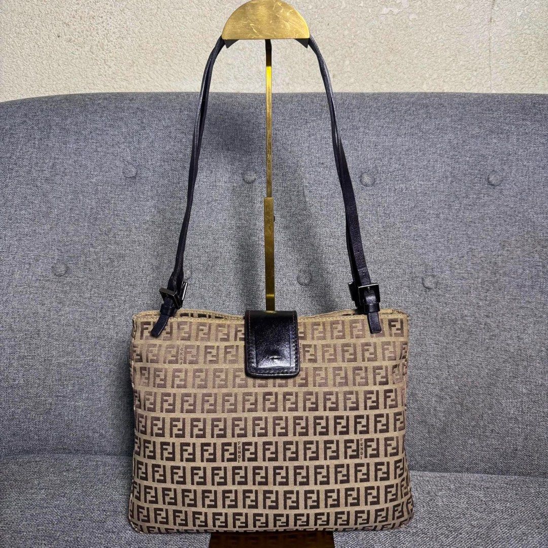 Fendi Zucca FF Monogram Canvas Shoulder Bag Brown (Category: Luxury Bags & Wallets) located in Madrid. Submitted by jhunaceee (Listing ID 1470943704, Image 2). Description: - Authentic Fendi vintage shoulder bag - Iconic brown Zucca monogram canvas - Adjustable dark leather double straps - Secure front flap with magnetic snap closure - Spacious interior that easily fits daily essentials - Perfect daily carryall for commutes or weekend outings.