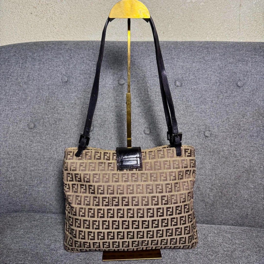 Fendi Zucca FF Monogram Canvas Shoulder Bag Brown (Category: Luxury Bags & Wallets) located in Madrid. Submitted by jhunaceee (Listing ID 1470943704, Image 1). Description: - Authentic Fendi vintage shoulder bag - Iconic brown Zucca monogram canvas - Adjustable dark leather double straps - Secure front flap with magnetic snap closure - Spacious interior that easily fits daily essentials - Perfect daily carryall for commutes or weekend outings.