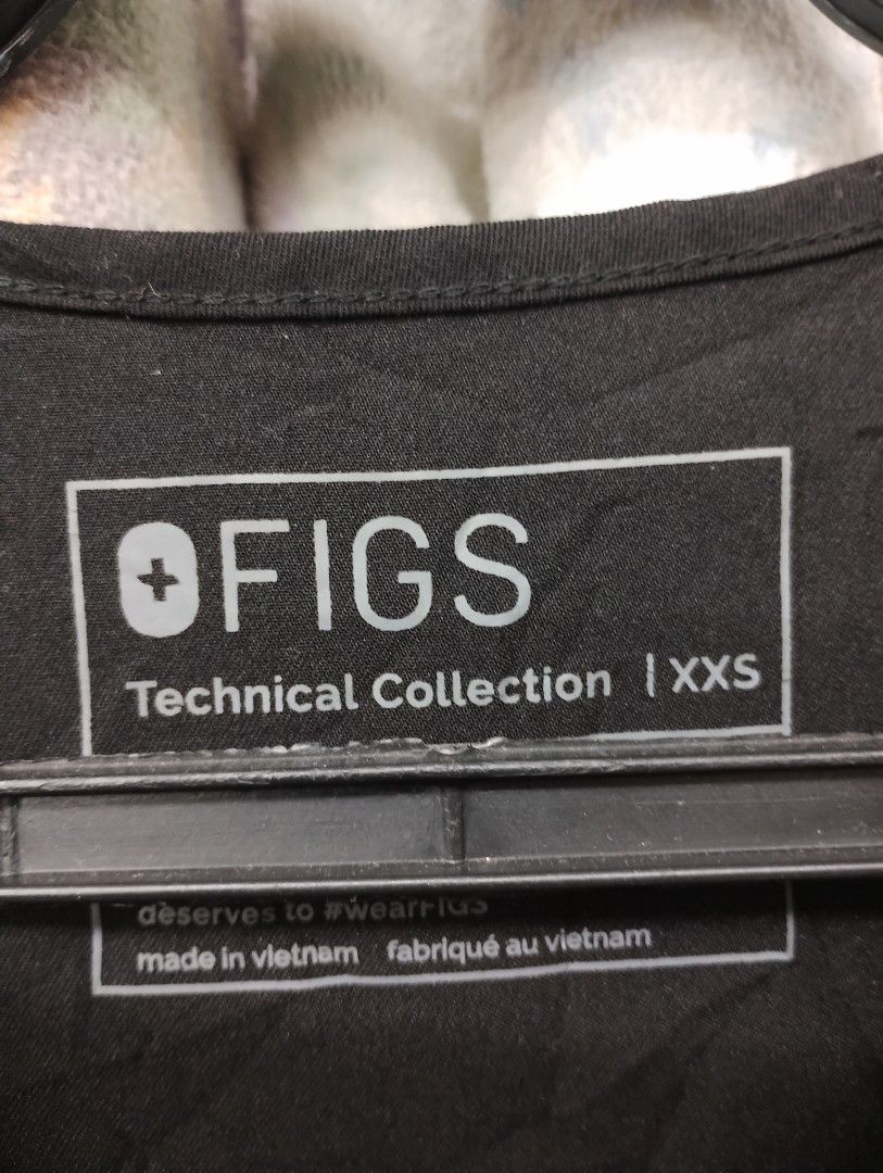 FIGS Technical Collection Black Scrubs Top Size XXS (Category: Activewear) located in Imus. Submitted by darylg88358770 (Listing ID 1470938769, Image 2). Description: - Brand: FIGS (Technical Collection) - Color: Black - Size: XXS - Details: Features embroidered 'Valley Pointe Nursing and Rehab' logo on the chest pocket - Material: 72% polyester, 21% viscose, 7% elastane (super soft, stretchy, and durable) - Design: V-neckline with short sleeves 