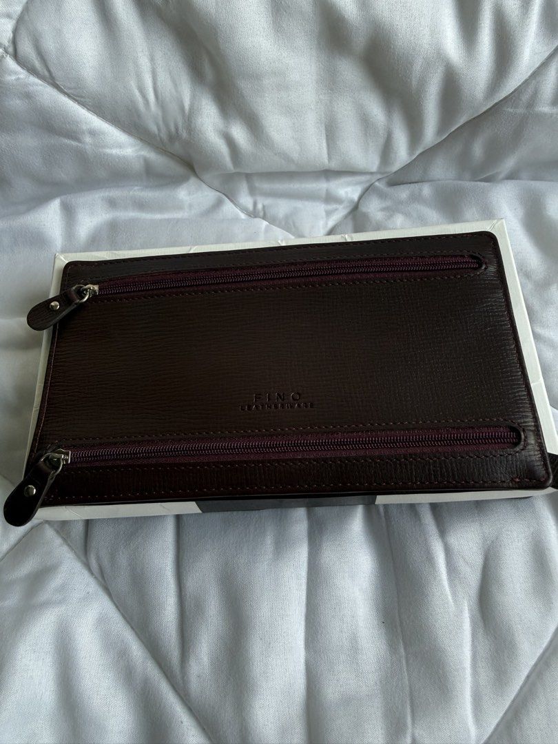Fino Leatherware (Category: Wallets & Card holders) located in Pasig City. Submitted by weng0952 (Listing ID 1471027983, Image 3). Description: - Brand: Fino Leatherware - Color: Burgundy( red wine)with quality textured leather construction - Storage: Multiple exterior zippered pockets, interior card slots, and main cash compartment - Inclusions: Comes with original white presentation box - Condition: Excellent, well-maintained - Shipping: Fast s