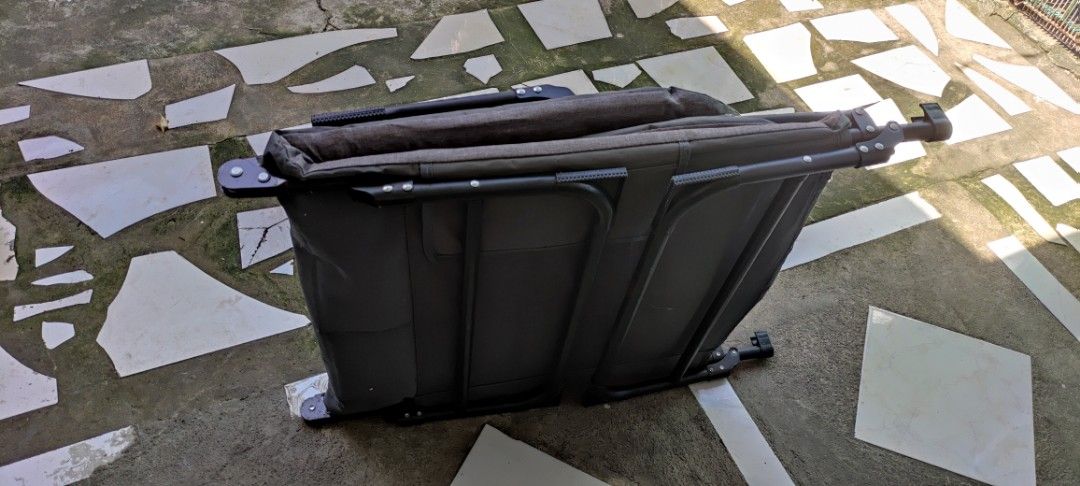 Foldable Grey Lounge Bed Cot with Pillow (Category: Outdoor Furniture) located in Dasmarinas. Submitted by jdelacruz0728 (Listing ID 1471085276, Image 2). Description: - Color/Material: Grey fabric with a sturdy black metal frame - Features: Built-in pillow section for head support - Portability: Folds compactly in half for easy storage and transport - Condition: Minor fraying on the top edge near the middle; fabric shows light wear - Usage: Grea