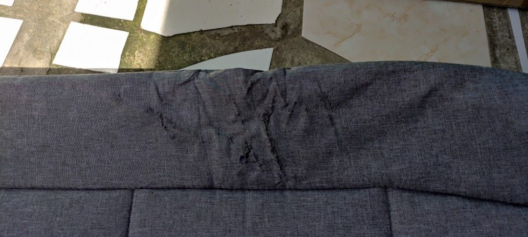 Foldable Grey Lounge Bed Cot with Pillow (Category: Outdoor Furniture) located in Dasmarinas. Submitted by jdelacruz0728 (Listing ID 1471085276, Image 3). Description: - Color/Material: Grey fabric with a sturdy black metal frame - Features: Built-in pillow section for head support - Portability: Folds compactly in half for easy storage and transport - Condition: Minor fraying on the top edge near the middle; fabric shows light wear - Usage: Grea