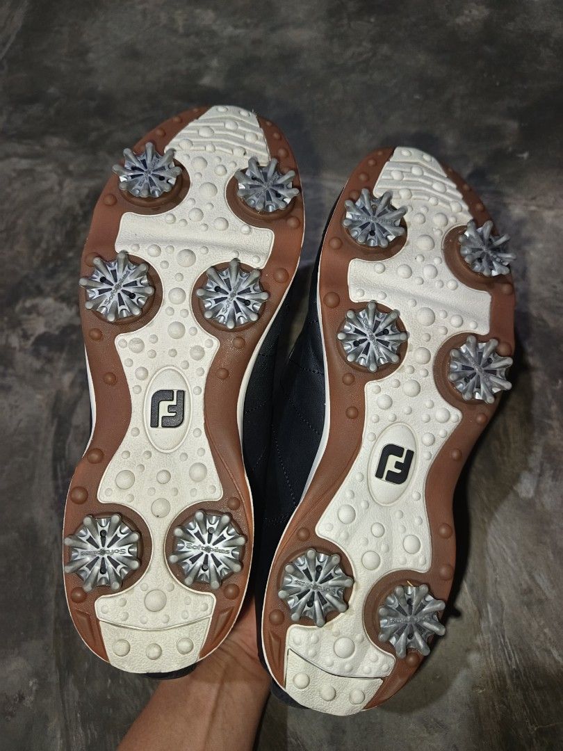 FootJoy Black Golf Shoes with Spikes (Category: Golf) located in Davao. Submitted by judethrifter (Listing ID 1471078167, Image 3). Description: FootJoy golf shoes in black leather. Dial lacing system across the top for quick tightening. White and brown outsoles fitted with Softspikes metal studs for traction on the course. Padded inner collar around the ankle. Solid grip underneath. Ready for the next round..