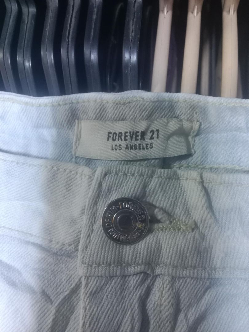 Forever 21 White Distressed Denim Shorts Size 24 (Category: Shorts) located in Quezon City. Submitted by honeyonline.ph (Listing ID 1471047220, Image 3). Description: - Brand: Forever 21 - Size: 24 - Color: Light wash white denim - Style: Raw hem with frayed edges and front distressed details - Design: Classic five-pocket styling with button and zip fly closure - Origin: Made in Pakistan - Condition: Excellent pre-loved or brand new (ready to wea