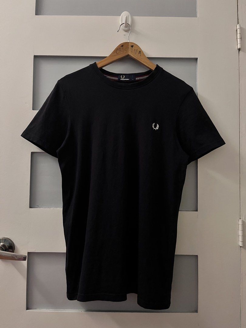 Fred Perry Black T-Shirt Size S (Category: Tshirts & Polo Shirts ) located in Calasiao. Submitted by cristinabarongan5 (Listing ID 1471058759, Image 1). Description: Black crew neck t-shirt from Fred Perry. Size S fits true to size. Classic laurel wreath embroidery on the chest in white. Tipped collar detail with burgundy and white stripes. Made in China, 100% cotton material. Clean inside tags and clear branding at the neck label. Great basic pi