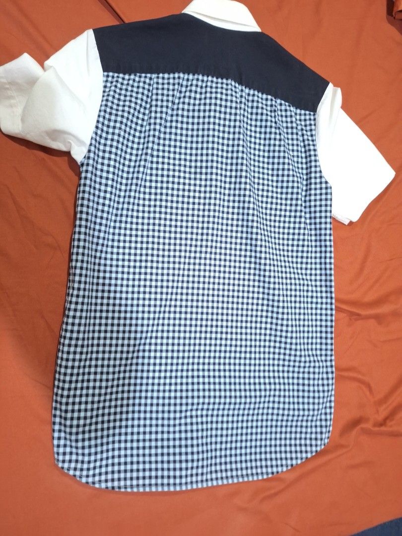 Fred Perry Short Sleeve Button Down Shirt XS (Category: Tshirts & Polo Shirts ) located in Manila. Submitted by adolphreyes645 (Listing ID 1471059407, Image 3). Description: - Brand: Fred Perry - Size: XS - Style: Short-sleeve button-down shirt - Design: White front with navy shoulder yoke and blue/white gingham check back - Details: Embroidered laurel wreath logo on the chest, collared neck - Condition: Pre-loved with noticeable yellowing on the