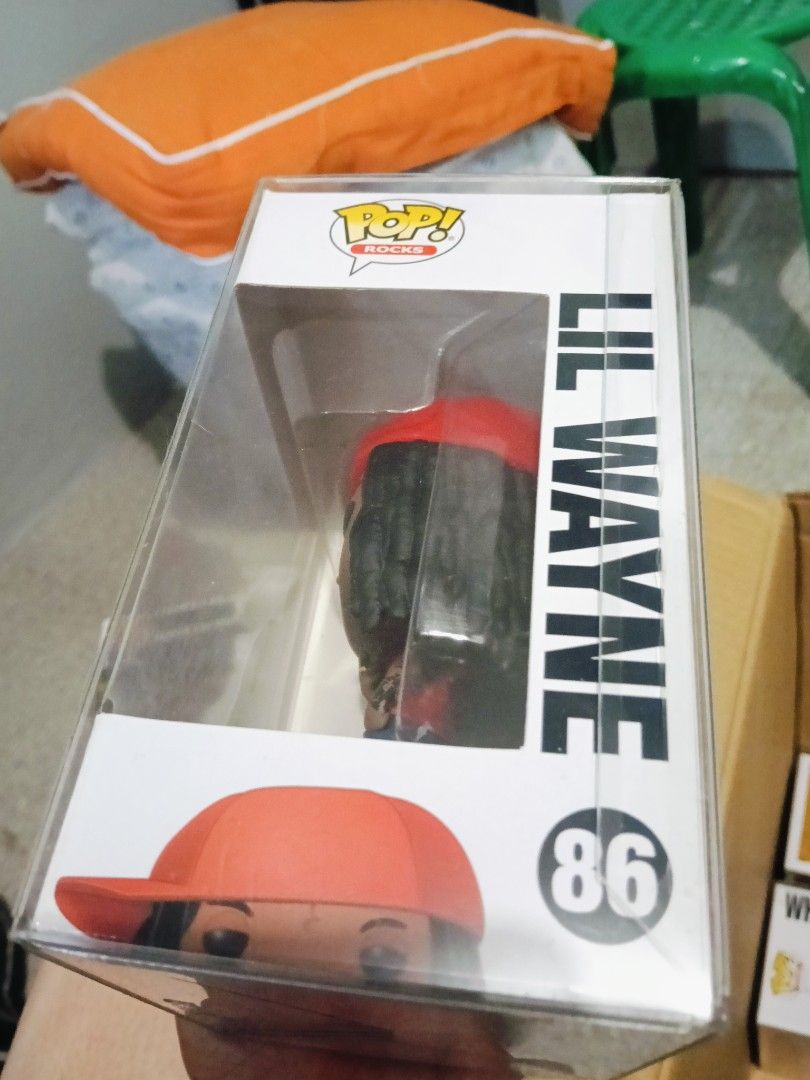 Funko Pop Rocks Lil Wayne #86 (Category: Designer & Blind Box Toys) located in Imus. Submitted by leihernandez_16 (Listing ID 1470984619, Image 2). Description: - Figure: Funko Pop! Rocks - Lil Wayne (#86) - Outfit: Red hat with matching red and white outfit - Condition: Box is clean and intact - Protection: Comes in a clear protective hard plastic case - Ideal for: Hip-hop collections and music memorabilia displays.