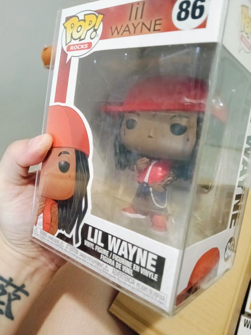 Funko Pop Rocks Lil Wayne #86 (Category: Designer & Blind Box Toys) located in Imus. Submitted by leihernandez_16 (Listing ID 1470984619, Image 1). Description: - Figure: Funko Pop! Rocks - Lil Wayne (#86) - Outfit: Red hat with matching red and white outfit - Condition: Box is clean and intact - Protection: Comes in a clear protective hard plastic case - Ideal for: Hip-hop collections and music memorabilia displays.
