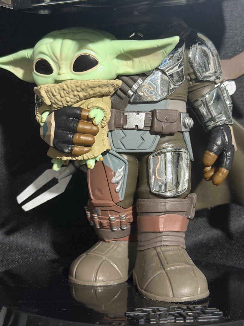 Funko Pop Star Wars The Mandalorian and Grogu (Category: Figurines & Statues) located in Manila. Submitted by niemaedc (Listing ID 1470990380, Image 2). Description: - Large Funko Pop: The Mandalorian holding Grogu - Features eye-catching shiny chrome helmet and armor accents - Includes a black Star Wars display stand - Condition: Dust-free and carefully handled - Ideal centerpiece for any Star Wars collector's shelf.