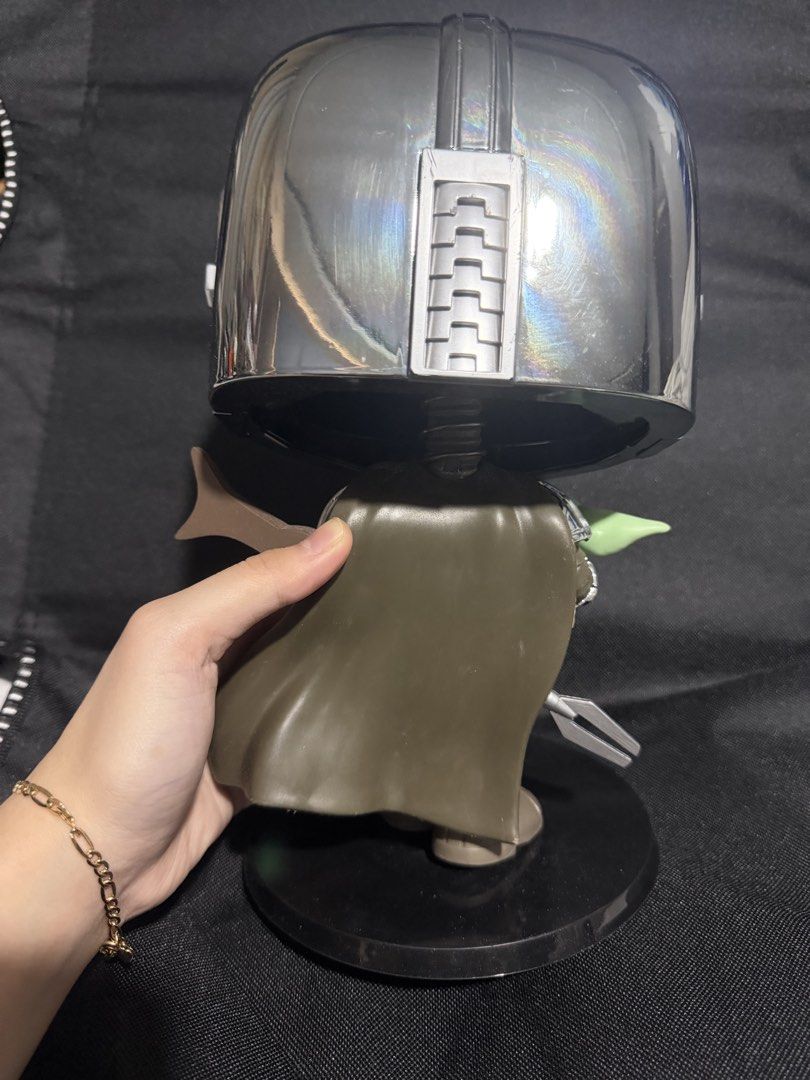 Funko Pop Star Wars The Mandalorian and Grogu (Category: Figurines & Statues) located in Manila. Submitted by niemaedc (Listing ID 1470990380, Image 3). Description: - Large Funko Pop: The Mandalorian holding Grogu - Features eye-catching shiny chrome helmet and armor accents - Includes a black Star Wars display stand - Condition: Dust-free and carefully handled - Ideal centerpiece for any Star Wars collector's shelf.